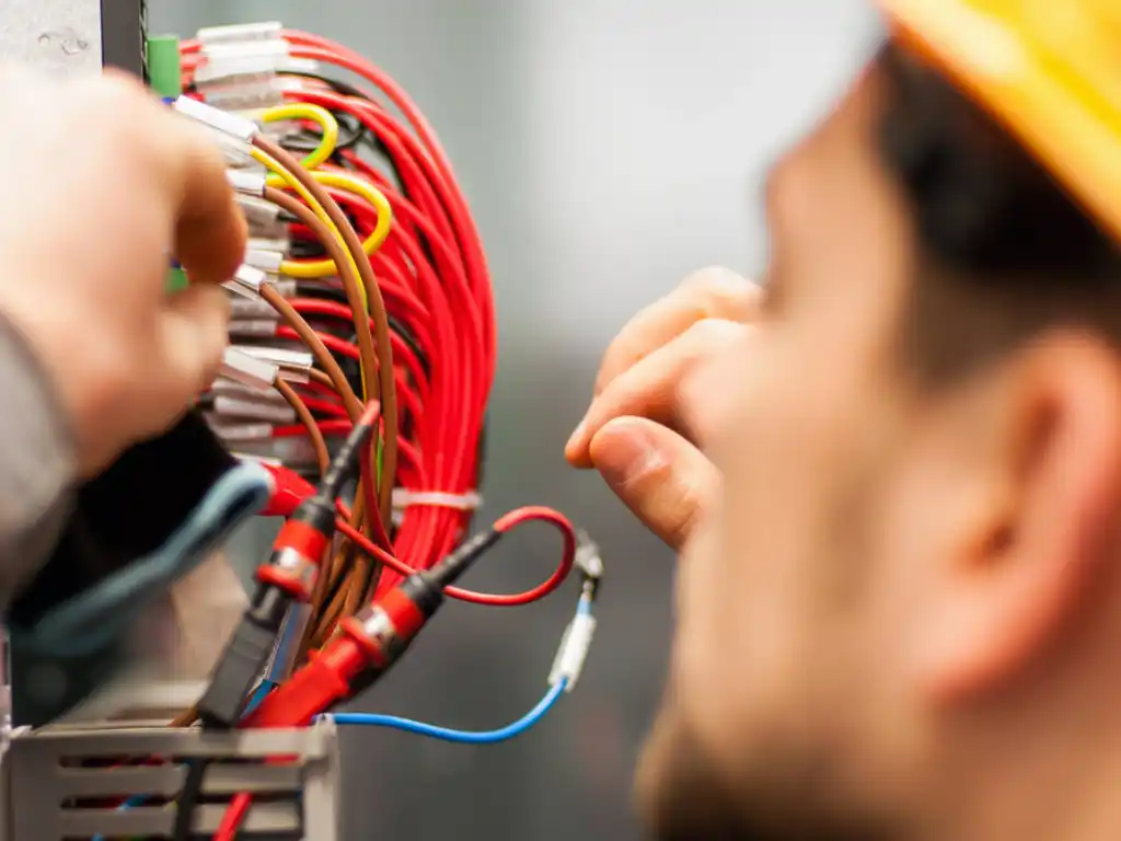 Electrician working on wiring panel